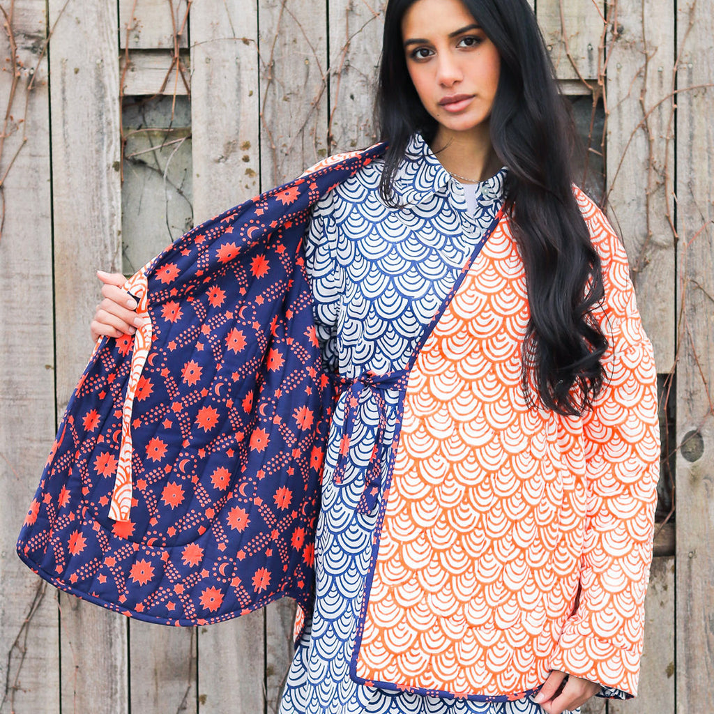 A woman in a quilted blockprinted reversible jacket showing both sides of jacket